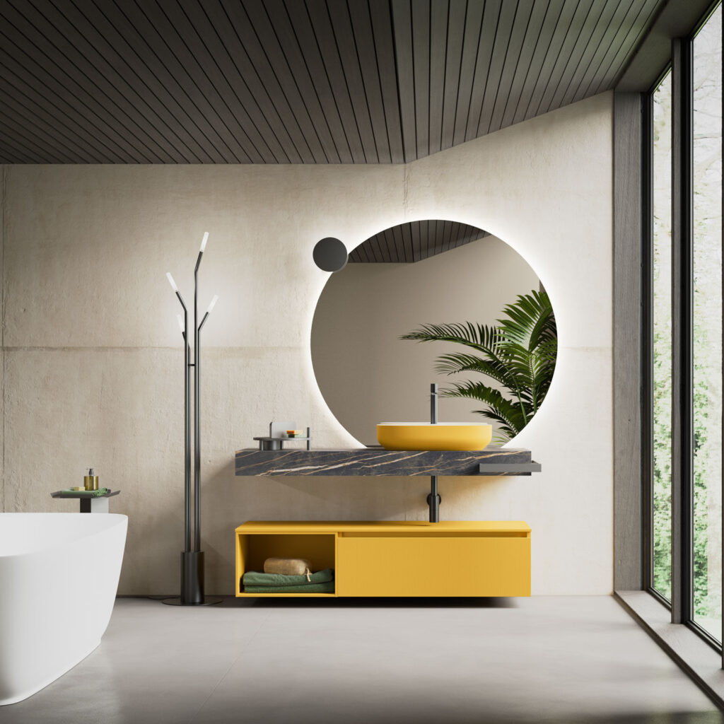 Bagno moderno con lavabo giallo e specchio tondo illuminato