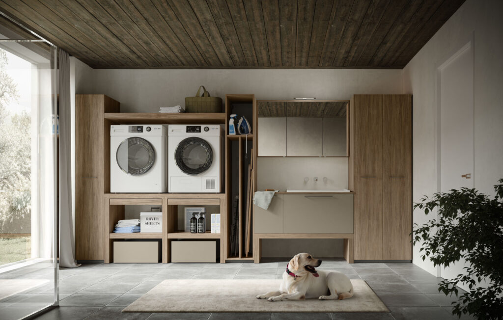 Lavanderia moderna con mobili in legno, lavatrice, asciugatrice e cane su tappeto chiaro